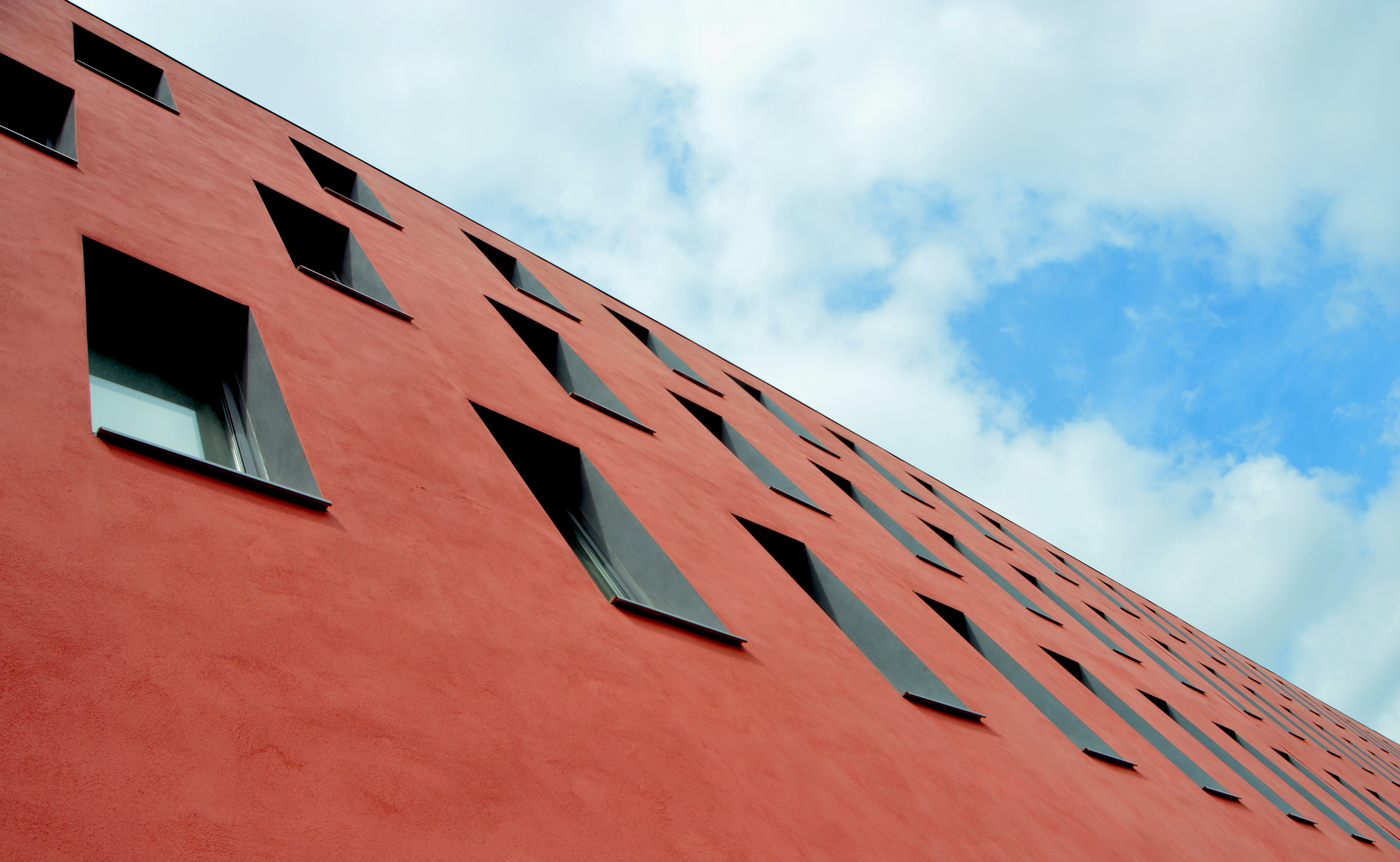 low-angle photography of red concrete building